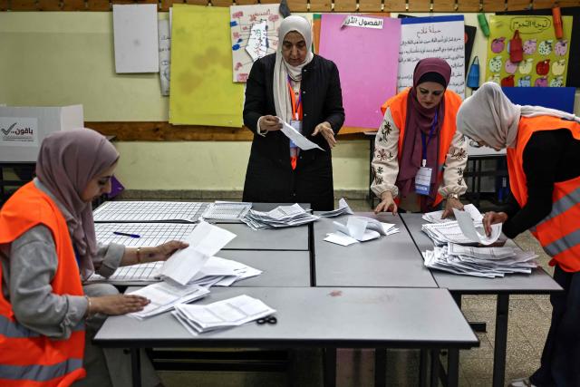 Palestinian electoral employees begin counting votes for the municipal elections after the close of polling stations in the Israeli-occupied West Bank city of Al-Bireh on April 25, 2026. Palestinians in the West Bank and a central area of Gaza began voting on April 25 in municipal elections in a first vote since the Gaza war, marked by a narrow political field and widespread disillusionment. (Photo by Zain JAAFAR / AFP)