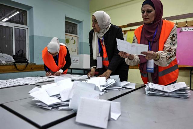 Palestinian electoral employees begin counting votes for the municipal elections after the close of polling stations in the Israeli-occupied West Bank city of Al-Bireh on April 25, 2026. Palestinians in the West Bank and a central area of Gaza began voting on April 25 in municipal elections in a first vote since the Gaza war, marked by a narrow political field and widespread disillusionment. (Photo by Zain JAAFAR / AFP)