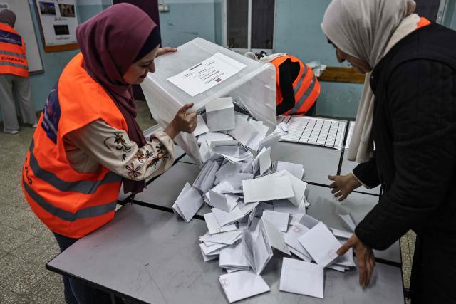 Palestinian electoral employees begin counting votes in the municipal elections after the close of polling stations in the Israeli-occupied West Bank city of Al-Bireh on April 25, 2026. Palestinians in the West Bank and a central area of Gaza began voting on April 25 in municipal elections in a first vote since the Gaza war, marked by a narrow political field and widespread disillusionment. (Photo by Zain JAAFAR / AFP)