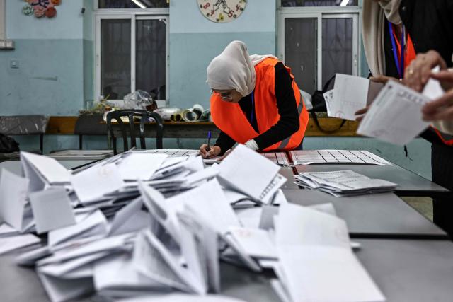 Palestinian electoral workers begin counting votes after the close of polling stations in the Israeli-occupied West Bank city of Al-Bireh on April 25, 2026. Palestinians in the West Bank and a central area of Gaza began voting on April 25 in municipal elections in a first vote since the Gaza war, marked by a narrow political field and widespread disillusionment. (Photo by Zain JAAFAR / AFP)