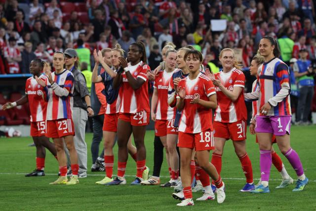 Bayern players including Bayern Munich's Japanese midfielder #18 Momoko Tanikawa (front) celebrate with their fans after the UEFA Women's Champions League semi-final first leg football match between FC Bayern Munich and FC Barcelona in Munich, southern Germany on April 25, 2026. (Photo by Karl-Josef HILDENBRAND / AFP)