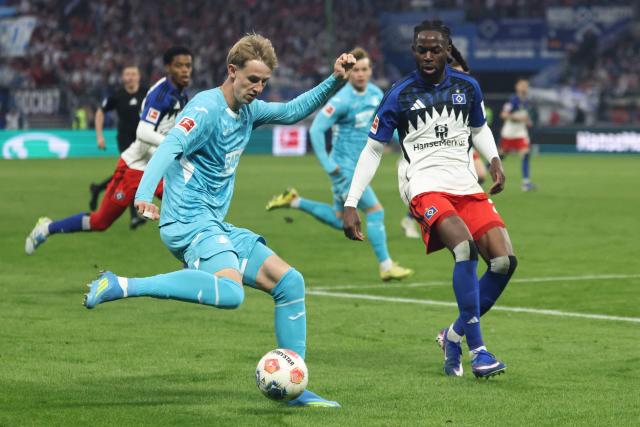 Hoffenheim's German forward #33 Max Moerstedt (L) and Hamburg's Nigerian defender #25 Jordan Torunarigha vie for the ball during the German first division Bundesliga football match between Hamburger SV and TSG 1899 Hoffenheim in Hamburg, northern Germany on April 25, 2026. (Photo by Ibrahim OT / AFP) / DFL REGULATIONS PROHIBIT ANY USE OF PHOTOGRAPHS AS IMAGE SEQUENCES AND/OR QUASI-VIDEO