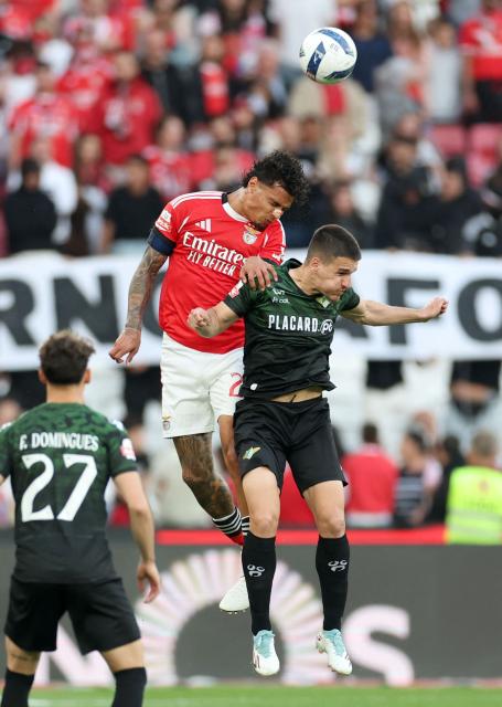 SL Benfica's Colombian midfielder #20 Richard Rios jumps for the ball next to Moreirense's Serbian midfielder #08 Mateja Stjepanovic during the Portuguese League football match between SL Benfica and Moreirense FC at Luz Stadium in Lisbon on April 25 , 2026. (Photo by PATRICIA DE MELO MOREIRA / AFP)