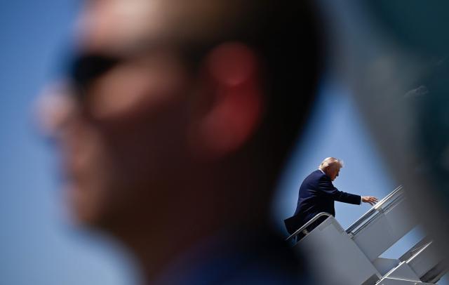 US President Donald Trump boards Air Force One at Palm Beach International Airport in West Palm Beach, Florida, on April 25, 2026. President Trump is on his way back to Washington where he will be attending the White House Correspondents' dinner for the first time while in office. (Photo by Kent NISHIMURA / AFP)