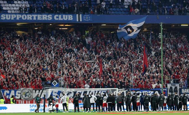 Hamburg's players celebrate with fans after the German first division Bundesliga football match between Hamburger SV and TSG 1899 Hoffenheim in Hamburg, northern Germany on April 25, 2026. Hoffenheim won the match 2-1. (Photo by Ibrahim OT / AFP) / DFL REGULATIONS PROHIBIT ANY USE OF PHOTOGRAPHS AS IMAGE SEQUENCES AND/OR QUASI-VIDEO