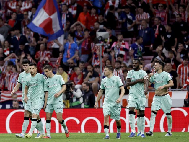 Athletic Bilbao's Spanish defender #04 Aitor Paredes (R) celebrates with teammates scoring his team's first goal during the Spanish league football match between Club Atletico de Madrid and Athletic Club Bilbao at the Metropolitano stadium in Madrid on April 25, 2026. (Photo by Oscar DEL POZO / AFP)