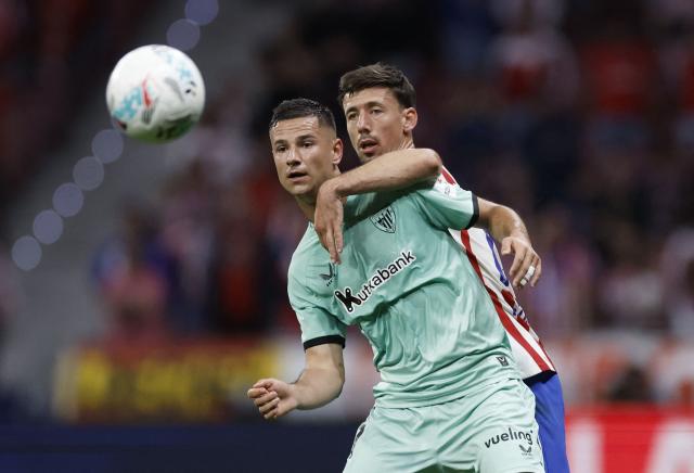 Athletic Bilbao's Spanish forward #11 Gorka Guruzeta fights for the ball with Atletico Madrid's French defender #15 Clement Lenglet during the Spanish league football match between Club Atletico de Madrid and Athletic Club Bilbao at the Metropolitano stadium in Madrid on April 25, 2026. (Photo by Oscar DEL POZO / AFP)