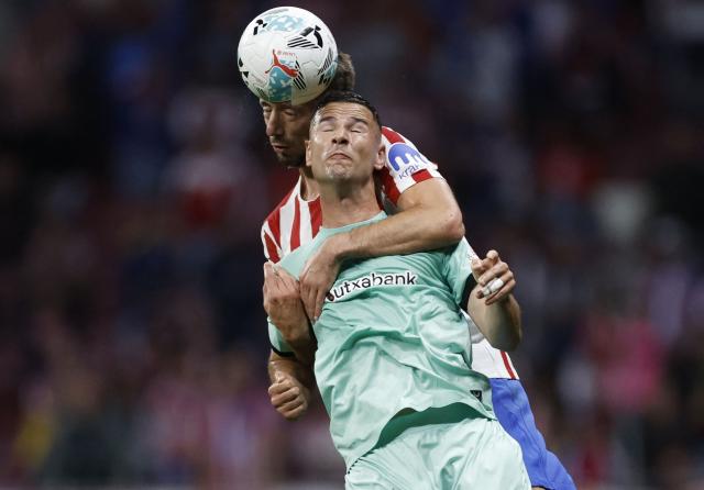 Athletic Bilbao's Spanish forward #11 Gorka Guruzeta fights for the ball with Atletico Madrid's French defender #15 Clement Lenglet during the Spanish league football match between Club Atletico de Madrid and Athletic Club Bilbao at the Metropolitano stadium in Madrid on April 25, 2026. (Photo by Oscar DEL POZO / AFP)
