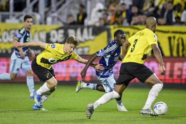 Ajax's Belgian midfielder #24 Jorthy Mokio (C) fights for the ball with NAC Breda's Australian midfielder #06 Max Balard (L) and NAC Breda's Belgian defender #03 Denis Odoi (R) during the Dutch Eredivisie football match between NAC Breda and Ajax at the Rat Verlegh Stadium in Breda on April 25, 2026. (Photo by Olaf Kraak / ANP / AFP) / Netherlands OUT