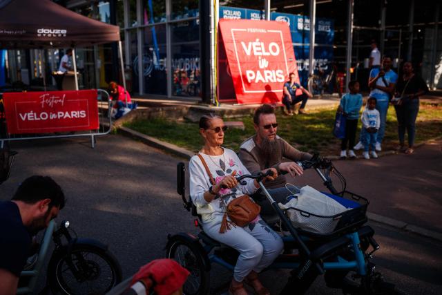 A couple test a new tandem bicycle during the Velo in Paris festival at the Parc Floral de Vincennes, in Vincennes, eastern Paris, on April 25, 2026. (Photo by Dimitar DILKOFF / AFP)