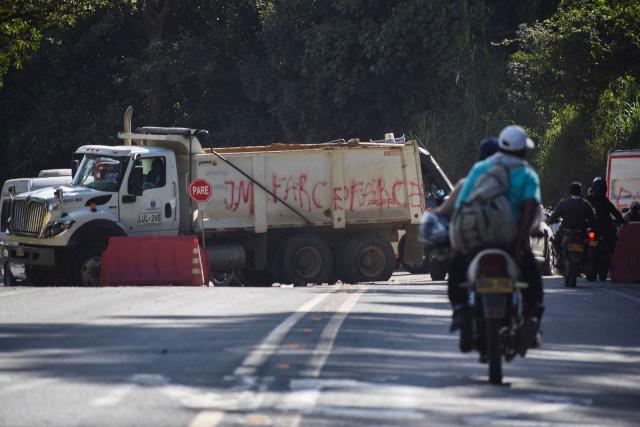 A truck blocked the way after a bomb attack at El Tunel, on the Popayan-Cali road, in Cajibio, Cauca department, Colombia, on April 25, 2026. A bomb attack on April 25 left seven people dead and 20 injured in an area of Colombia with a strong guerrilla presence, amid a spate of attacks just over a month before the presidential elections, the governor of the Cauca region said. (Photo by Francisco Calderon / AFP)