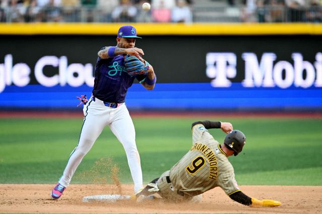 San Diego Padres' #09 Jake Cronenworth slides to second base in front of Arizona Diamondbacks' #04 Ketel Marte during the MLB World Tour Mexico City Series game between San Diego Padres and Arizona Diamondbacks at Alfredo Harp Helu Stadium in Mexico City on April 25, 2026. (Photo by YURI CORTEZ / AFP)