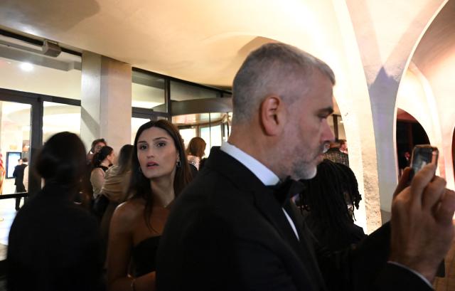 Guests rush out of the Washington Hilton after loud bangs were heard during the White House Correspondents' Dinner in Washington, DC, on April 25, 2026. President Trump is attending the annual gala of the political press for the first time while in office. (Photo by Alex WROBLEWSKI / AFP)