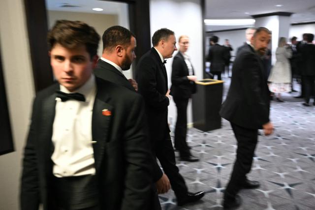 EPA Administrator Lee Zeldin (C) is escorted out of a safe room after loud bangs were heard during the White House Correspondents' dinner at the Washington Hilton in Washington, DC, on April 25, 2026. President Trump was evacuated from the dinner, which he was attending for the first time while in office. (Photo by Mandel NGAN / AFP)