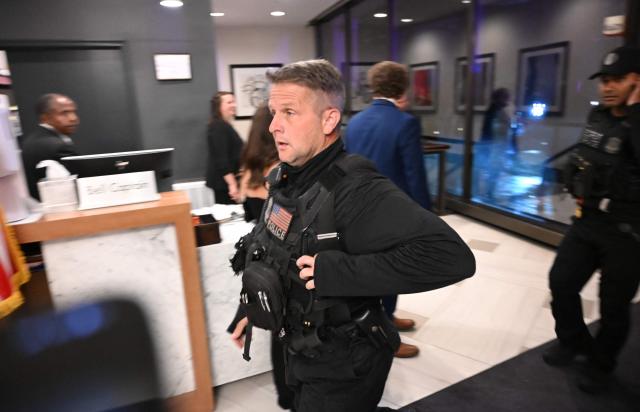 A police officer walks through the lobby of the Washington Hilton after shots were heard during the White House Correspondents' Dinner in Washington, DC, on April 25, 2026. President Trump is attending the annual gala of the political press for the first time while in office. (Photo by Alex WROBLEWSKI / AFP)