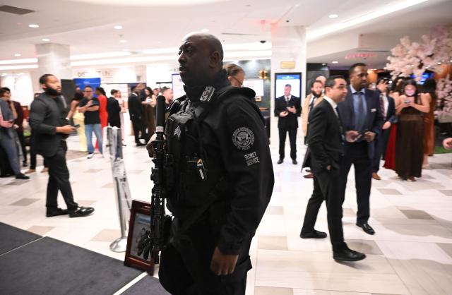 A Secret Service officer walks through the lobby of the Washington Hilton after shots were heard during the White House Correspondents' Dinner in Washington, DC, on April 25, 2026. President Trump is attending the annual gala of the political press for the first time while in office. (Photo by Alex WROBLEWSKI / AFP)