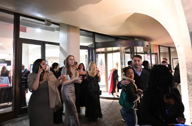 Guests leave the Washington Hilton amid a heavy police presence after shots were heard during the White House Correspondents Dinner in Washington, DC, on April 25, 2026. Shots were fired as US President Donald Trump attended a press dinner in Washington on April 25 night, witnesses and AFP reporters confirmed. Loud bangs were heard and guests at the black-tie White House Correspondents' Dinner scrambled to hide under tables. Tactical teams with guns drawn took position on the stage where Trump had been sitting before he was evacuated. (Photo by Alex WROBLEWSKI / AFP)