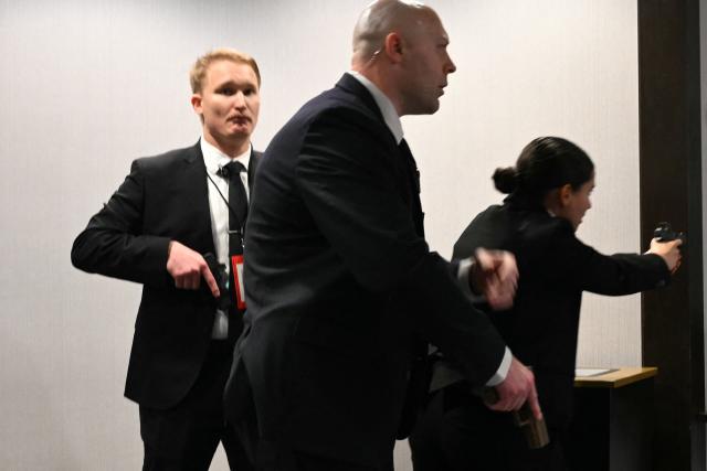 Agents draw their guns after loud bangs were heard during the White House Correspondents' dinner at the Washington Hilton in Washington, DC, on April 25, 2026. Shots were allegedly fired as US President Donald Trump attended a press dinner in Washington on Saturday night, witnesses and AFP reporters said as loud bangs were heard at the hotel venue. (Photo by Mandel NGAN / AFP)