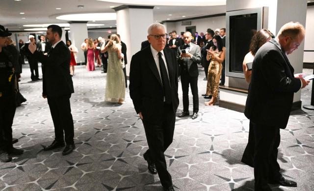 Co-founder of The Carlyle Group David Rubenstein walks back toward the ballroom at the Washington Hilton where shots were heard earlier during the White House Correspondents Dinner in Washington, DC, on April 25, 2026. Shots were fired as US President Donald Trump attended a press dinner in Washington on April 25 night, witnesses and AFP reporters confirmed. Loud bangs were heard and guests at the black-tie White House Correspondents' Dinner scrambled to hide under tables. Tactical teams with guns drawn took position on the stage where Trump had been sitting before he was evacuated. (Photo by Mandel NGAN / AFP)