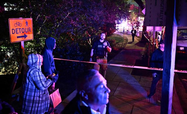A Secret Service officer stands guard behind police tape, blocking access to the Washington Hilton after shots were heard during the White House Correspondents Dinner in Washington, DC, on April 25, 2026. Shots were fired as US President Donald Trump attended a press dinner in Washington on April 25 night, witnesses and AFP reporters confirmed. Loud bangs were heard and guests at the black-tie White House Correspondents' Dinner scrambled to hide under tables. Tactical teams with guns drawn took position on the stage where Trump had been sitting before he was evacuated. (Photo by Kent NISHIMURA / AFP)