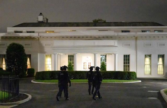 Secret Service counter assault team members walk past the West Wing of the White House in Washington, DC on April 25, 2026. President Donald Trump said April 25 he believes the suspected shooter who stormed the White House correspondents' dinner was a "lone wolf." "In my opinion, he was a lone wolf," Trump said, describing the man as a "whack job" and saying he felt there was no reason to believe the attack was connected to the war in Iran. (Photo by Mandel NGAN / AFP)