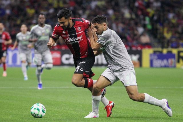 Atlas' forward #19 Eduardo Aguirre and America's Uruguayan defender #04 Sebastian Caceres fight for the ball during the Liga MX Clausura football match between America and Atlas at Banorte Stadium in Mexico City on April 25, 2026. (Photo by Victor Cruz / AFP)
