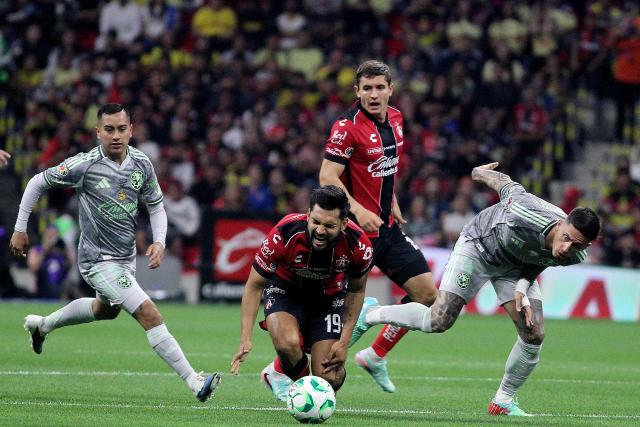 Atlas' forward #19 Eduardo Aguirre is fouled by America's Uruguayan midfielder #07 Brian Rodriguez (R) during the Liga MX Clausura football match between America and Atlas at Banorte Stadium in Mexico City on April 25, 2026. (Photo by Victor Cruz / AFP)