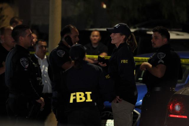FBI agents and police officers are seen near the home of the alleged White House Correspondents Dinner shooter in Torrance, California, on April 25, 2026. US President Donald Trump said April 25 he would give a press conference from the White House press briefing room, shortly after a shooting incident at a gala dinner in Washington. The press conference is set to take place shortly after 10 p.m. (0200 GMT), Trump wrote on his Truth Social platform, adding: "The First Lady, plus the Vice President, and all Cabinet members, are in perfect condition." (Photo by Patrick T. Fallon / AFP)