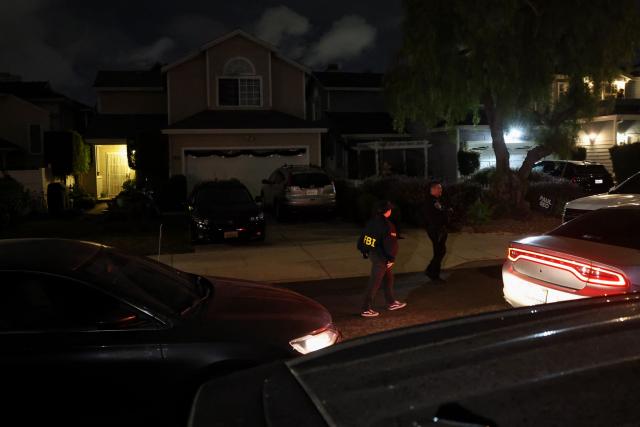 FBI agents walk outside the home of the alleged White House Correspondents Dinner shooter in Torrance, California, on April 25, 2026. US President Donald Trump said April 25 he would give a press conference from the White House press briefing room, shortly after a shooting incident at a gala dinner in Washington. The press conference is set to take place shortly after 10 p.m. (0200 GMT), Trump wrote on his Truth Social platform, adding: "The First Lady, plus the Vice President, and all Cabinet members, are in perfect condition." (Photo by Patrick T. Fallon / AFP)