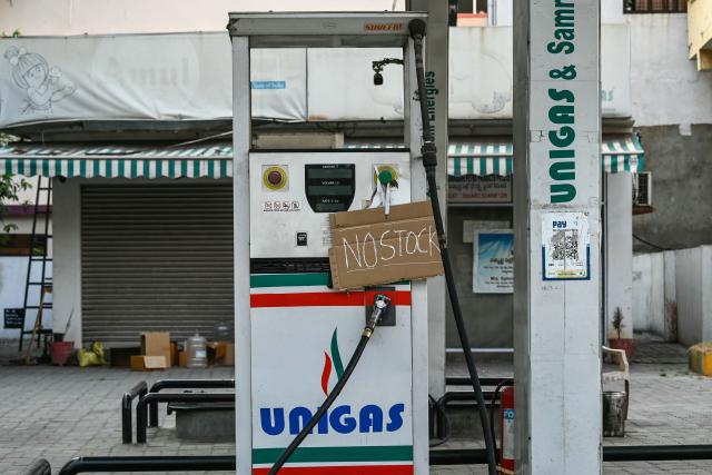 (FILES) A 'no stock' sign is displayed on a pump at a petrol station in Hyderabad on March 25, 2026 amid global energy crisis owing to the Middle East war. India has ramped up purchases of Russian oil in April 2026 and revived alternate supplies from Africa, Iran and Venezuela to blunt a sharp crude shortfall from the crisis-ridden Middle East, analysts say. (Photo by Noah SEELAM / AFP)