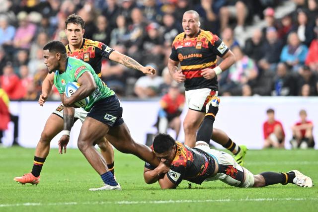 Fijian Drua's Zuriel Togatama (L) is tackled by Chiefs' defence during the Super Rugby Pacific match between the Chiefs and Fijian Drua at One New Zealand Stadium in Christchurch on April 26, 2026. (Photo by Sanka VIDANAGAMA / AFP)