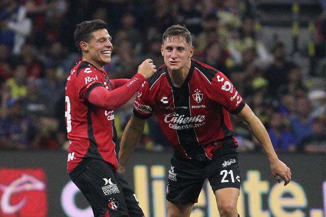 Atlas' forward #58 Arturo Gonzalez (L) celebrates with temamate Argentine defender #21 Rodrigo Schlegel after scoring the opening goal during the Liga MX Clausura football match between America and Atlas at Banorte Stadium in Mexico City on April 25, 2026. (Photo by Victor Cruz / AFP)
