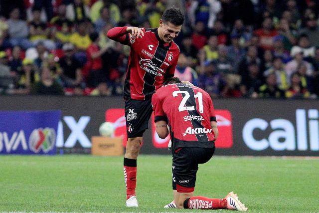 Atlas' forward #58 Arturo Gonzalez (L) celebrates with temamate Argentine defender #21 Rodrigo Schlegel after scoring the opening goal during the Liga MX Clausura football match between America and Atlas at Banorte Stadium in Mexico City on April 25, 2026. (Photo by Victor Cruz / AFP)