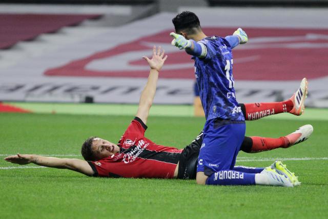 Atlas' Argentine defender #21 Rodrigo Schlegel celebrates with teammate Colombian goalkeeper #12 Camilo Vargas after winning the Liga MX Clausura football match between America and Atlas at Banorte Stadium in Mexico City on April 25, 2026. (Photo by Victor Cruz / AFP)