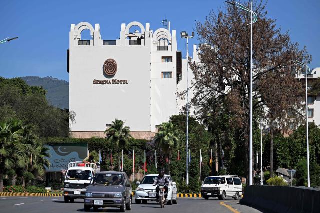 Commuters ride along a street in front of the Serena Hotel, that hosted the first round of US-Iran peace talks during the Middle East war, after authorities reopened the Red Zone area in Islamabad on April 26, 2026 following eased security measures and restrictions. Pakistan's Prime Minister Shehbaz Sharif said he had spoken to Iranian President Masoud Pezeshkian on April 25 after the second round of US-Iran negotiations in Islamabad were called off and reiterated Islamabad's commitment to facilitating "durable peace". (Photo by Aamir QURESHI / AFP)