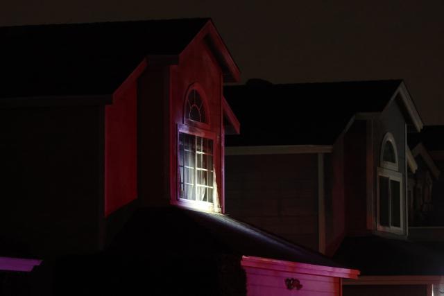 A spotlight shines on a house associated with the suspected White House Correspondents Dinner shooter as an FBI tactical team arrives in armored vehicles in Torrance, California, on April 25, 2026. US President Donald Trump said April 25 he would give a press conference from the White House press briefing room, shortly after a shooting incident at a gala dinner in Washington. The press conference is set to take place shortly after 10 p.m. (0200 GMT), Trump wrote on his Truth Social platform, adding: "The First Lady, plus the Vice President, and all Cabinet members, are in perfect condition." (Photo by Patrick T. Fallon / AFP)