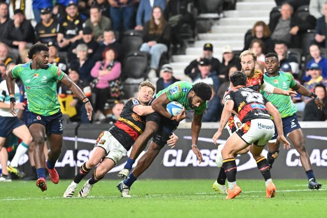 Fijian Drua's Kavaia Tagivetaua (C) is tackled by Chiefs' defence during the Super Rugby Pacific match between the Chiefs and Fijian Drua at One New Zealand Stadium in Christchurch on April 26, 2026. (Photo by Sanka VIDANAGAMA / AFP)