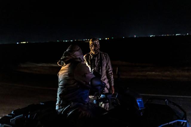 Members of the Mauritanian Coast Guard (GCM) talk to each other during a night patrol in Nouadhibou, on April 23, 2026. (Photo by PATRICK MEINHARDT / AFP)