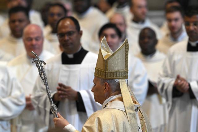 Pope Leo XIV (C) arrives for the Holy Mass with Priestly Ordinations, at St Peter's Basilica in the Vatican on April 26, 2026. (Photo by Andreas SOLARO / AFP)