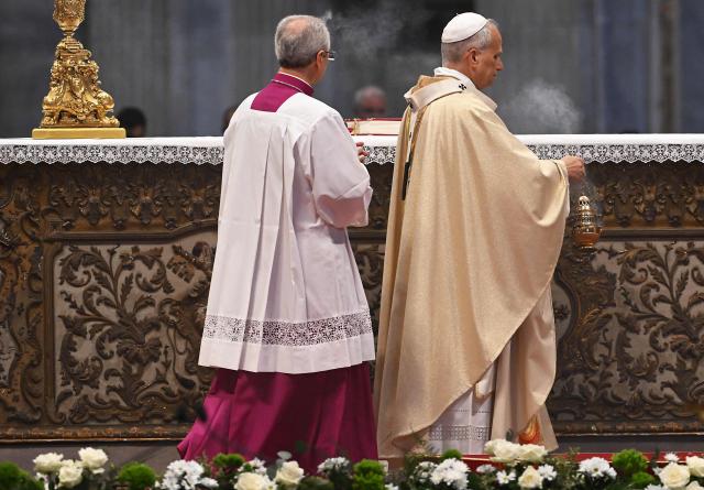 Pope Leo XIV (R) holds a fuming incense thurible as he presides over the Holy Mass with Priestly Ordinations, at St Peter's Basilica in the Vatican on April 26, 2026. (Photo by Andreas SOLARO / AFP)