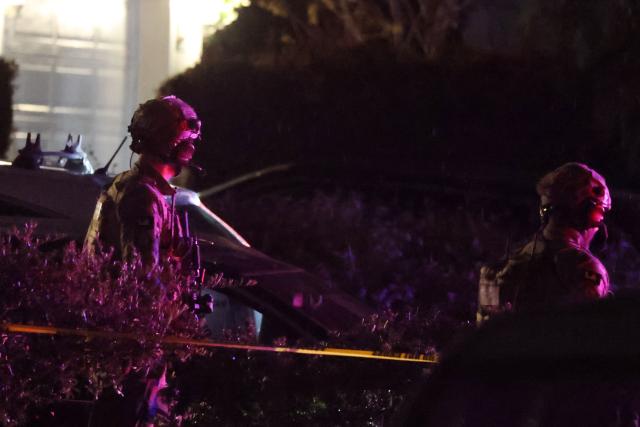 FBI tactical agents leave a house associated with the suspected White House Correspondents Dinner shooter after making entry at the residence in Torrance, California, late on April 25, 2026. US Secret Service agents bundled Donald Trump from the stage as shots rang out Saturday evening at a media gala, in what the president later described as an attack by a "would-be assassin." Armed guards opened fire at the gunman who charged through a security checkpoint just outside the ballroom of the hotel where Trump, First Lady Melania Trump, senior government officials and hundreds of other black-tie guests had gathered. (Photo by Patrick T. Fallon / AFP)