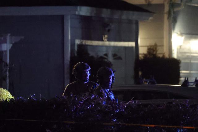 FBI tactical agents leave a house associated with the suspected White House Correspondents Dinner shooter after making entry at the residence in Torrance, California, late on April 25, 2026. US Secret Service agents bundled Donald Trump from the stage as shots rang out Saturday evening at a media gala, in what the president later described as an attack by a "would-be assassin." Armed guards opened fire at the gunman who charged through a security checkpoint just outside the ballroom of the hotel where Trump, First Lady Melania Trump, senior government officials and hundreds of other black-tie guests had gathered. (Photo by Patrick T. Fallon / AFP)