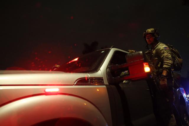 An FBI tactical agent departs on a vehicle after entering a house associated with the suspected White House Correspondents Dinner shooter in Torrance, California, early on April 26, 2026. US Secret Service agents bundled Donald Trump from the stage as shots rang out Saturday evening at a media gala, in what the president later described as an attack by a "would-be assassin." Armed guards opened fire at the gunman who charged through a security checkpoint just outside the ballroom of the hotel where Trump, First Lady Melania Trump, senior government officials and hundreds of other black-tie guests had gathered. (Photo by Patrick T. Fallon / AFP)