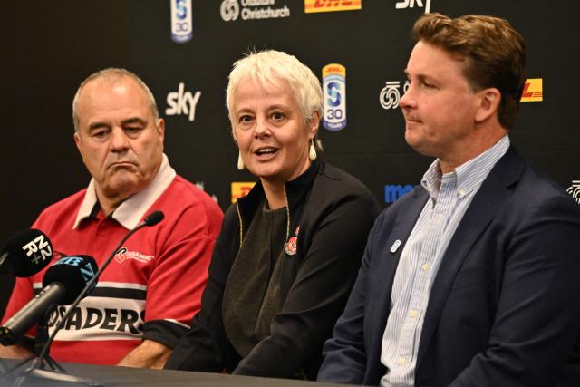 ChristchurchNZ's CEO Ali Adams (C) speaks to the media as Crusaders CEO Colin Mansbridge (L) and Super Rugby Pacific CEO Jack Mesley (R) look on during a press conference at One New Zealand Stadium in Christchurch on April 26, 2026. (Photo by Sanka VIDANAGAMA / AFP)