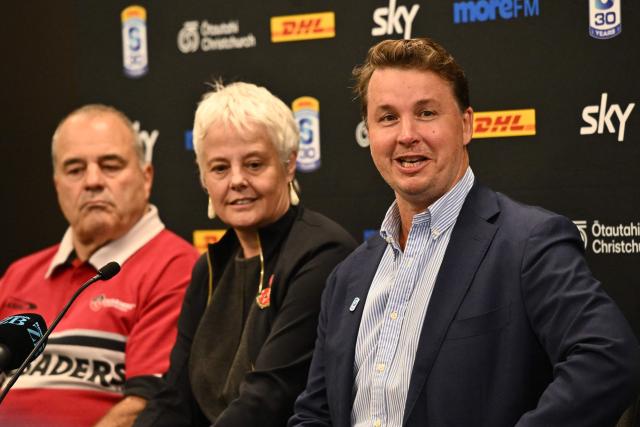 Super Rugby Pacific CEO Jack Mesley (R) speaks to the media as ChristchurchNZ's CEO Ali Adams (C) and Crusaders CEO Colin Mansbridge (L) look on during a press conference at One New Zealand Stadium in Christchurch on April 26, 2026. (Photo by Sanka VIDANAGAMA / AFP)