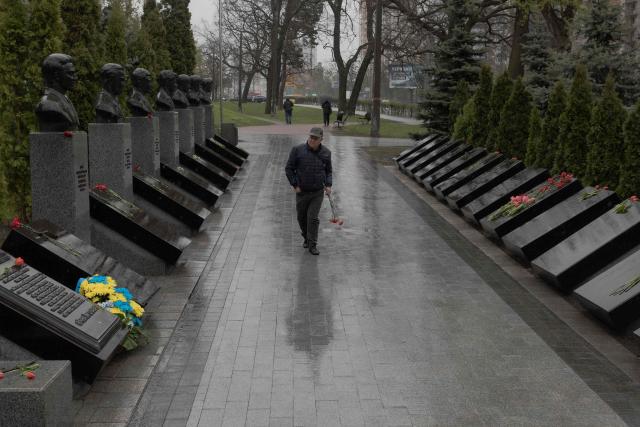 A man arrives to lay flowers at a memorial for the victims of Chernobyl, on the 40th anniversary of the explosion at the nuclear power plant, in Kyiv on April 26, 2026, amid the Russian invasion of Ukraine. Chernobyl accident, the worst civilian nuclear disaster in history. The risks of new radioactive releases still remain today, as the site is threatened by Russian strikes after it invaded the neighbour four years ago. (Photo by Roman PILIPEY / AFP)