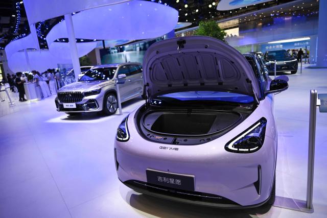 The booth of the Chinese automaker Geely is seen at the Beijing Auto Show in Beijing on April 26, 2026. (Photo by Pedro PARDO / AFP)