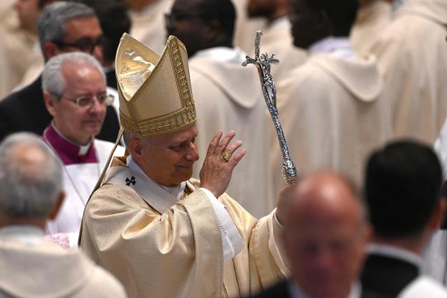 Pope Leo XIV (C) waves at the end of the Holy Mass with Priestly Ordinations, at St Peter's Basilica in the Vatican on April 26, 2026. (Photo by Andreas SOLARO / AFP)