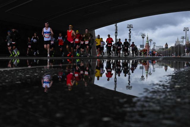 Participants of the Moscow Half Marathon run along Kremlevskaya embankment under the Moskvoretsky bridge past the Kremlin in central Moscow on April 26, 2026. (Photo by Igor IVANKO / AFP)