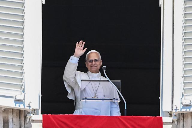 Pope Leo XIV waves from the window of the apostolic palace overlooking St. Peter's square during the Regina Coeli prayer in The Vatican on April 26, 2025. (Photo by Andreas SOLARO / AFP)